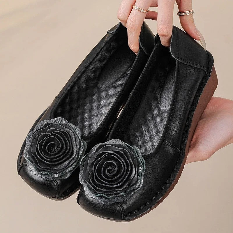 Stylish women's loafers featuring intricate floral appliqué design and a comfortable slip-on fit for casual wear.