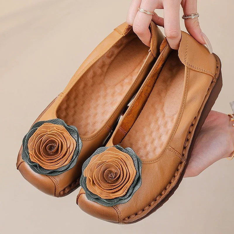 Elegant women's slip-on loafers featuring decorative floral appliqué, designed for ultimate comfort and style.
