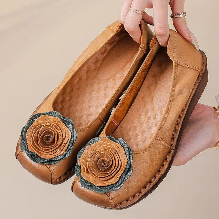 Elegant women's slip-on loafers featuring decorative floral appliqué, designed for ultimate comfort and style.