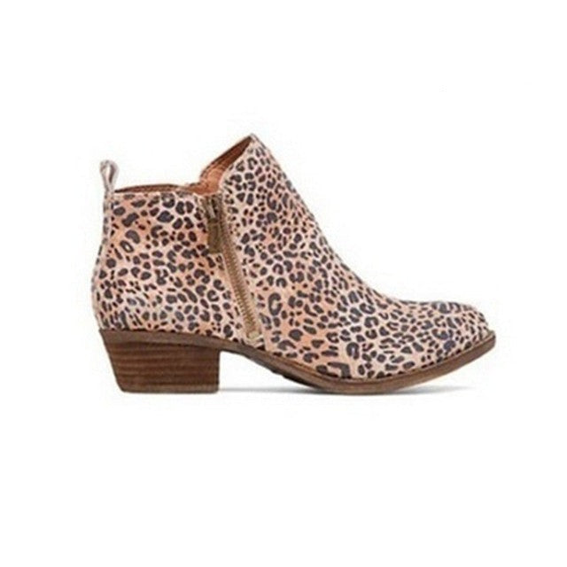 Detailed view of women's ankle boots showing side zip, comfortable block heel, and elegant rounded toe.