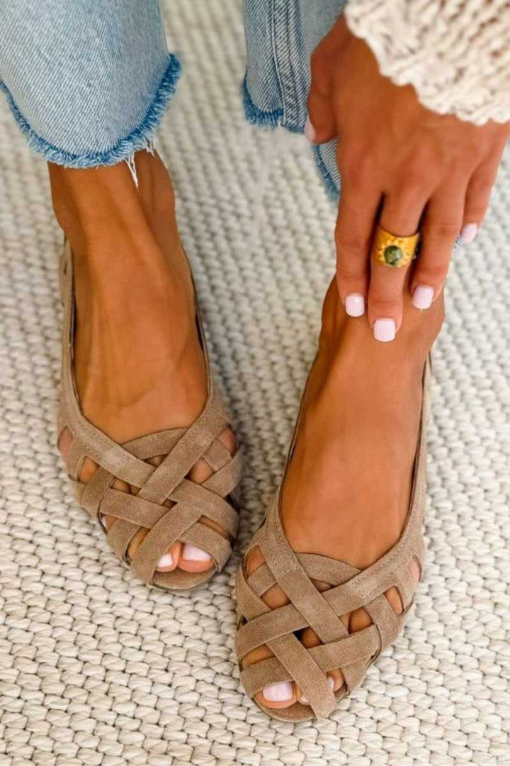 Woman wearing comfortable braided crossover strap sandals, ideal for beach or vacation.