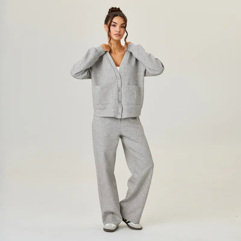 Modern navy blue women's knit lounge set. Comfortable, relaxed fit cardigan and trousers, ideal for casual wear.