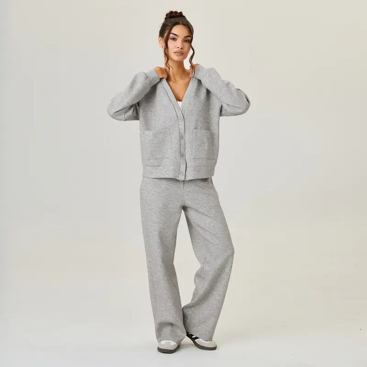 Modern navy blue women's knit lounge set. Comfortable, relaxed fit cardigan and trousers, ideal for casual wear.