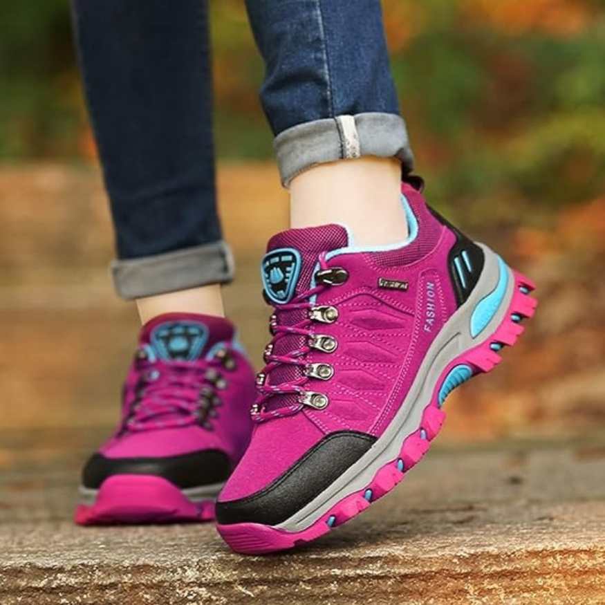 Close-up of women's athletic hiking shoes in pink and gray, designed for outdoor trails