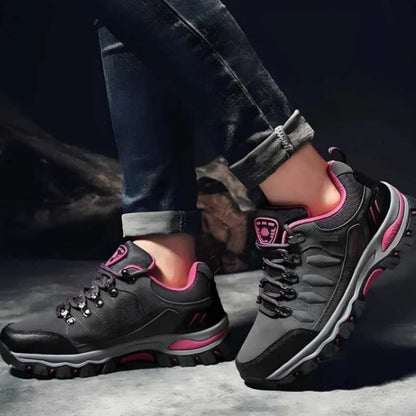 Women's pink and gray hiking shoes, showcasing robust design for trail walking and comfort