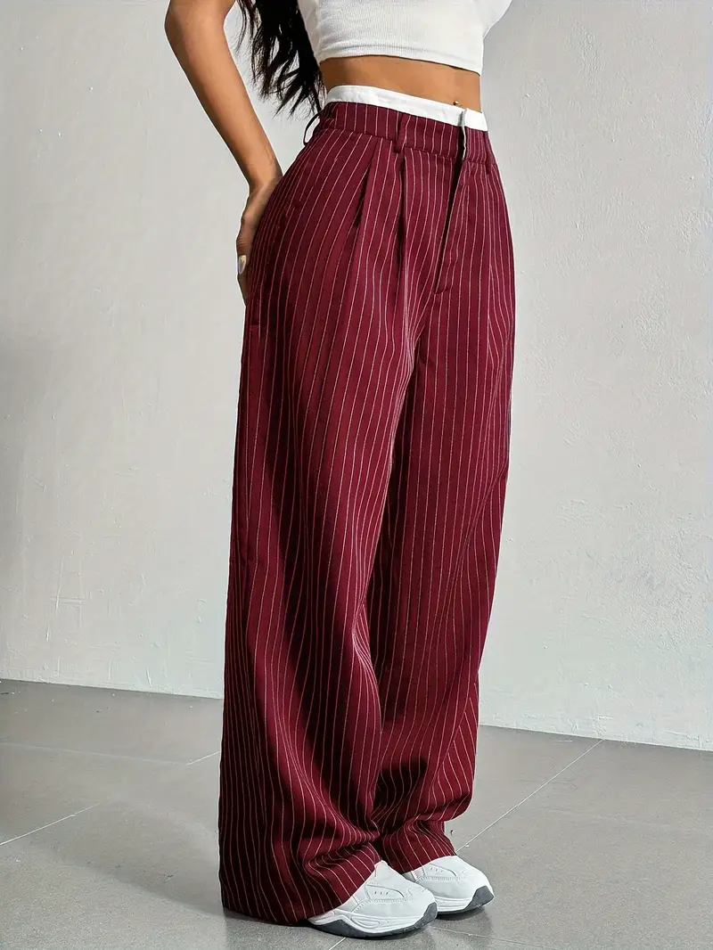 Detailed view of women's pinstripe wide-leg trousers, highlighting the fabric and relaxed, flowing design.