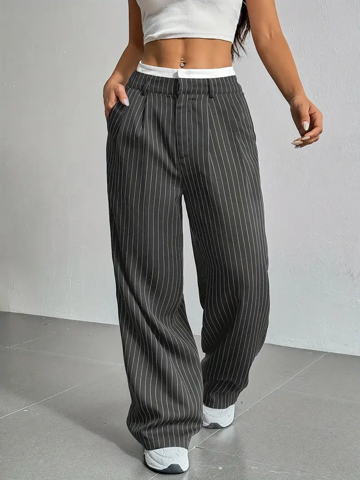 Comfortable women's pinstripe wide-leg trousers, blending ease of wear with a stylish, modern aesthetic.