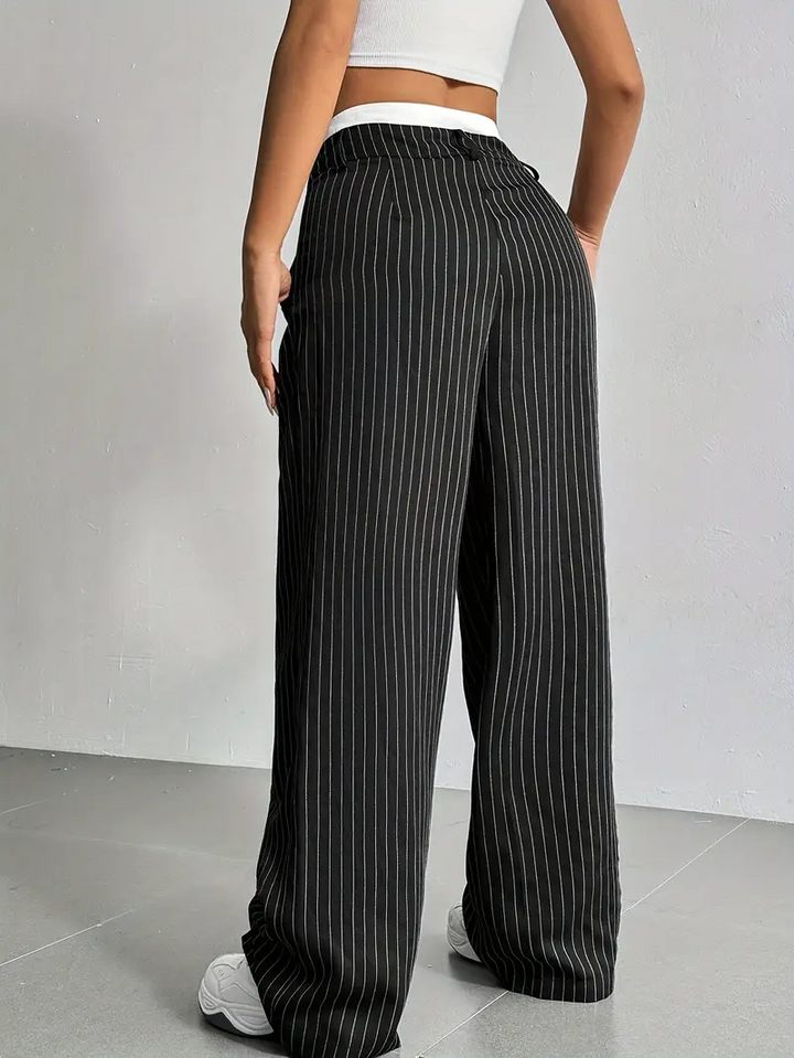 Elegant pinstripe wide-leg trousers for women, versatile for casual outings or sophisticated office wear.