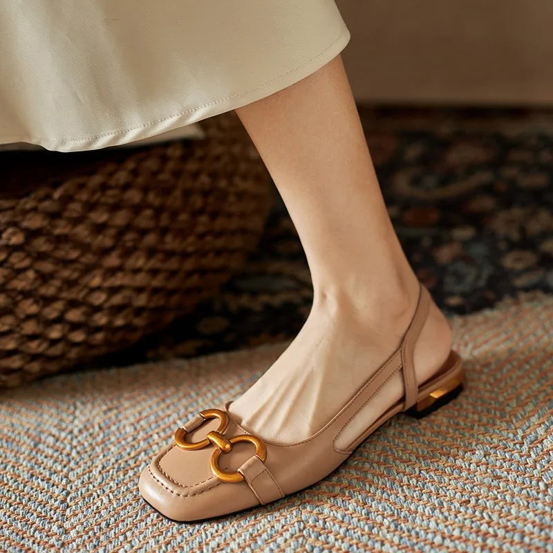 Comfortable and fashionable women's slingback flats with an elegant gold-tone chain embellishment.