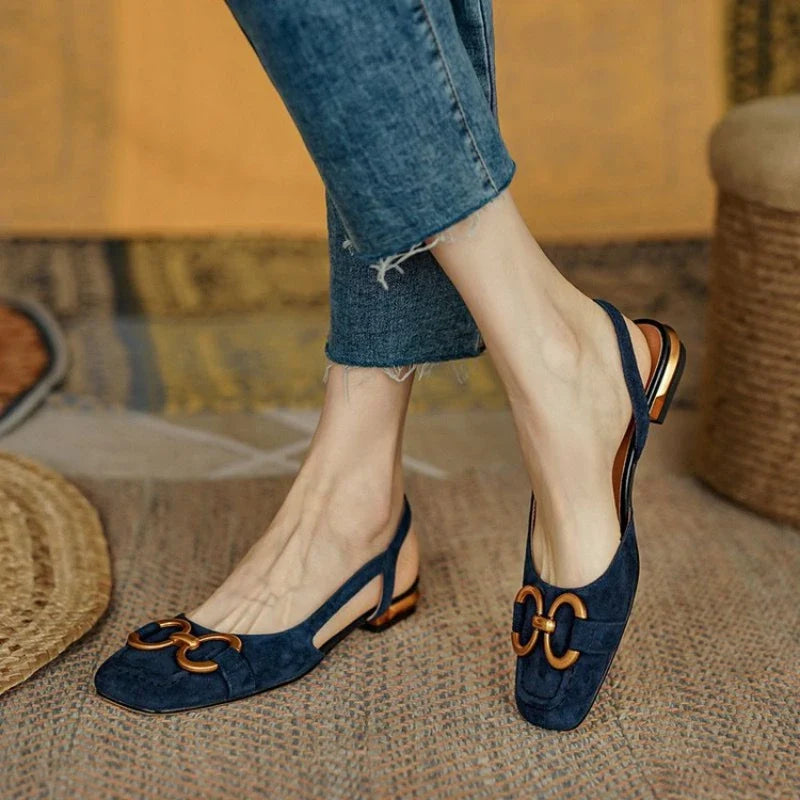 Elegant women's slingback flats with gold chain, offering comfort and style for any occasion.