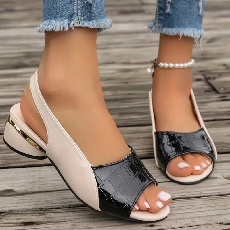 Modern women's slingback slip-on sandals, comfortable with a low heel and contemporary croc texture.