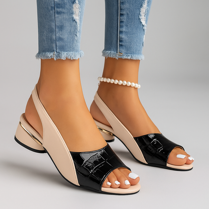 Experience comfort with these women's slingback slip-on sandals, featuring croc texture & a low heel.