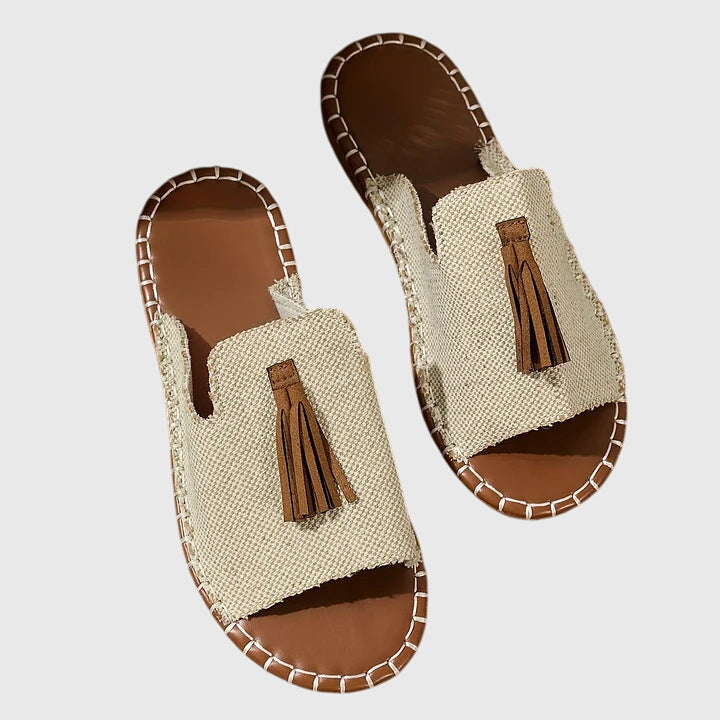Women's casual slip-on sandals with comfortable flat sole, elegant tassel straps for summer style.