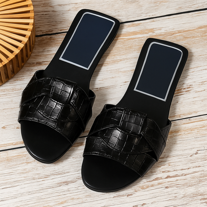Chic women's open-toe flat slide sandals, perfect for casual summer days and everyday style.