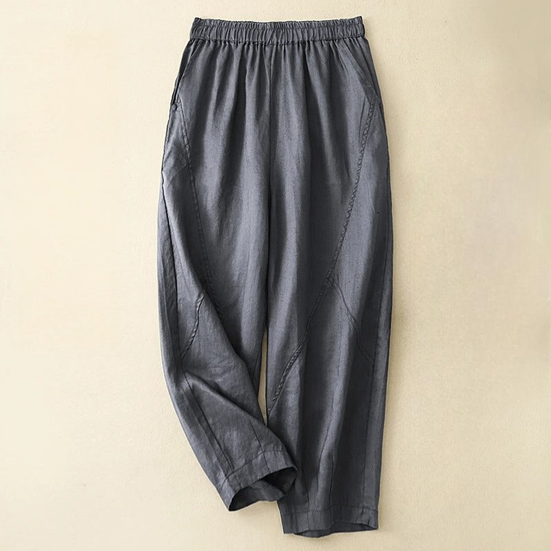 Close-up of soft fabric on women's tapered pants with elastic waist. Comfortable and chic everyday fashion essentials.