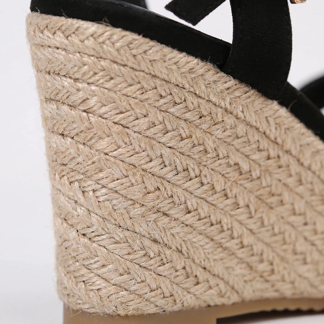 Black women's wedge sandals with adjustable strap, comfortable for both casual and dressy summer outfits.