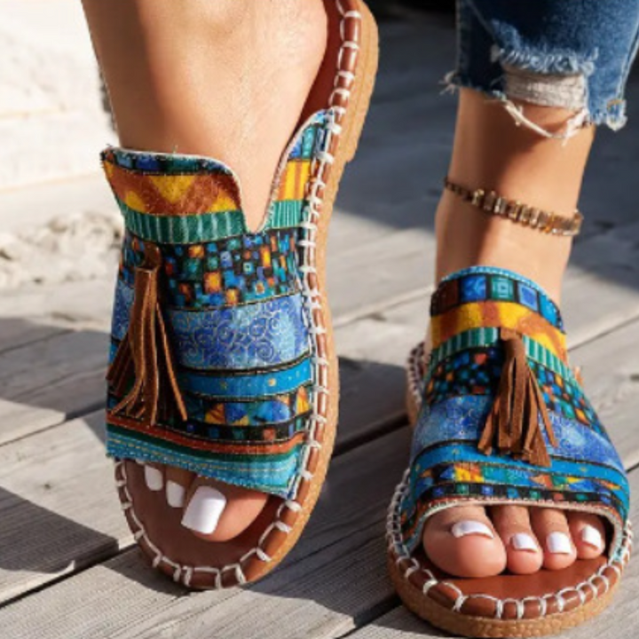 Chic open-toe women's flat sandals, perfect slip-on footwear for summer vacations.