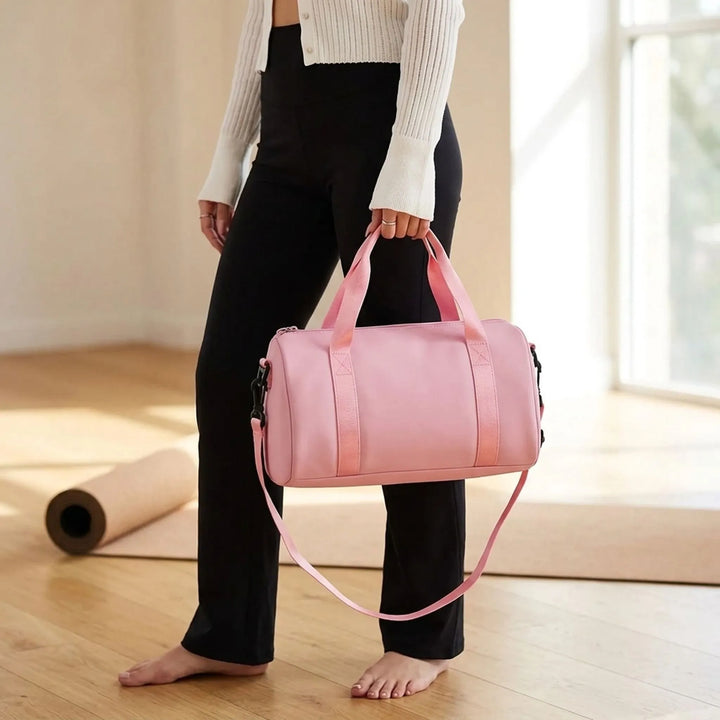 Women's compact gym duffel bag, lightweight & water-resistant, perfect for workouts or travel.