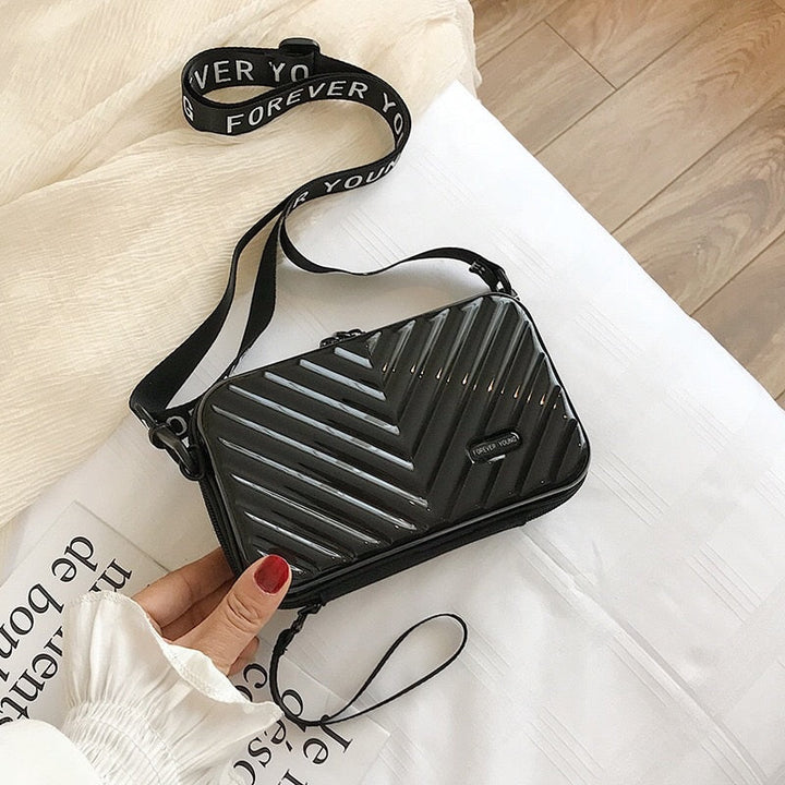 Stylish women's hard shell travel crossbody bag. Durable & water-resistant compact shoulder bag.