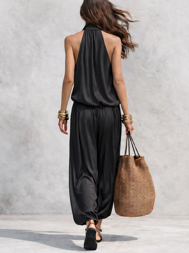 Flowy bohemian women's two-piece set featuring draped cowl neck halter top & wide leg pants, ideal for vacation.