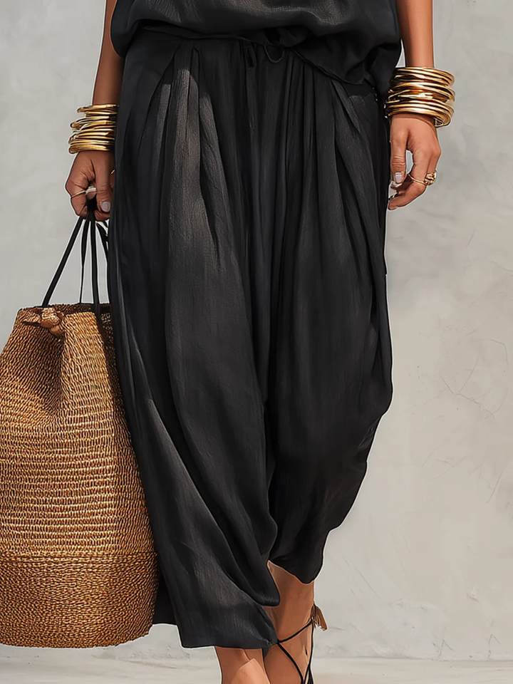 Chic women's two-piece set with a flattering cowl neck halter top & wide leg pants, great for summer fashion.