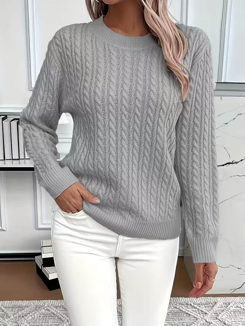 Front view of a women's cozy cable knit crew neck sweater, showcasing its soft texture & autumn fashion.
