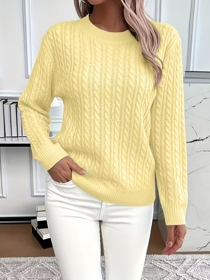 Side profile of a relaxed-fit women's cable knit jumper, highlighting its cozy design & autumn versatility.