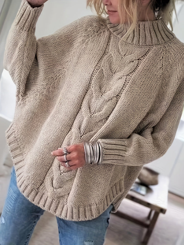Fall fashion women's cable knit high-neck sweater. Oversized & cozy with a stylish flared hem.
