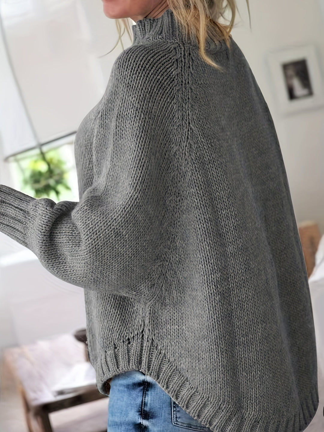 Casual chic women's cable knit sweater. High-neck, flared hem, and cozy oversized design for everyday style.