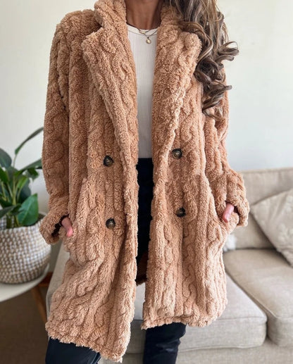 Fashionable women's cable knit overcoat, a warm winter jacket. Stylish long outerwear perfect for elegant layering.