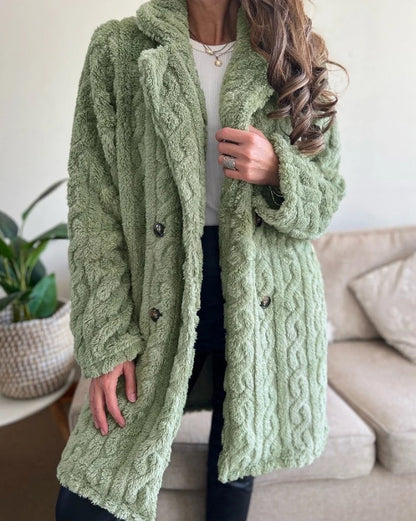 Elegant women's cable knit overcoat, a warm and cozy winter jacket. Stylish long outerwear for chic fashion layering.