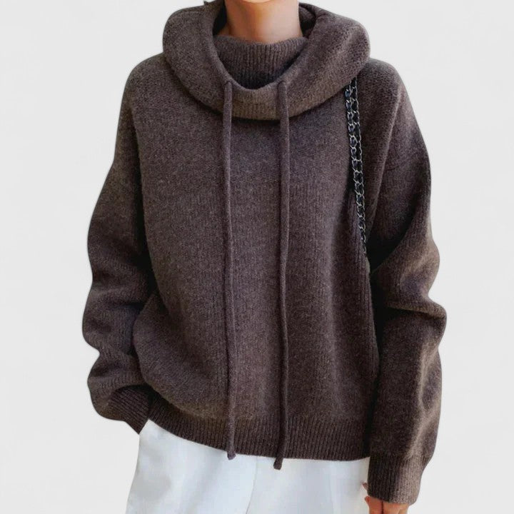 Comfortable women's oversized pullover sweater with a cozy cowl neck and adjustable drawstring. Relaxed fit.