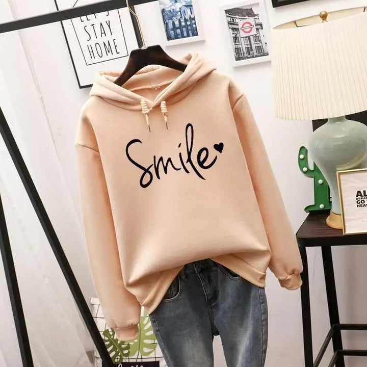 Women's cozy hoodie with a vibrant smile graphic. Perfect for casual comfort & positive vibes in fall/winter.