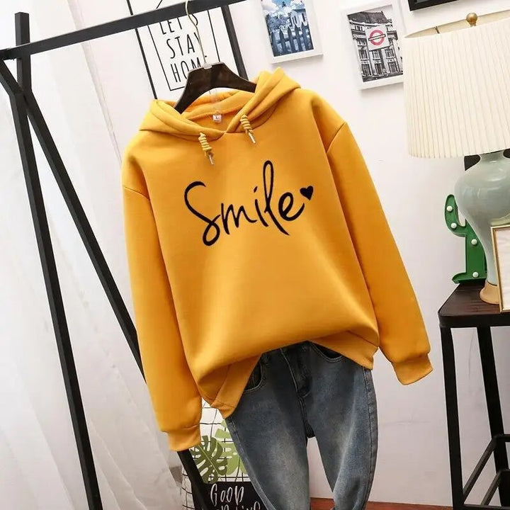 Soft women's cozy sweatshirt with a feel-good smile graphic. Perfect for relaxed comfort & positive energy.