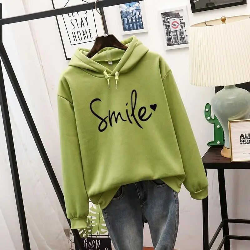 Chic women's smile graphic hoodie for ultimate comfort. A cozy, relaxed fit top for everyday positive style.