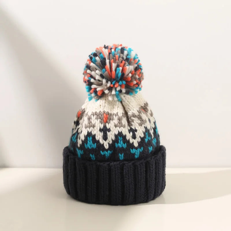 Stylish women's warm knit winter beanie, snowflake design with cute pompom, casual accessory.