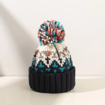 Stylish women's warm knit winter beanie, snowflake design with cute pompom, casual accessory.
