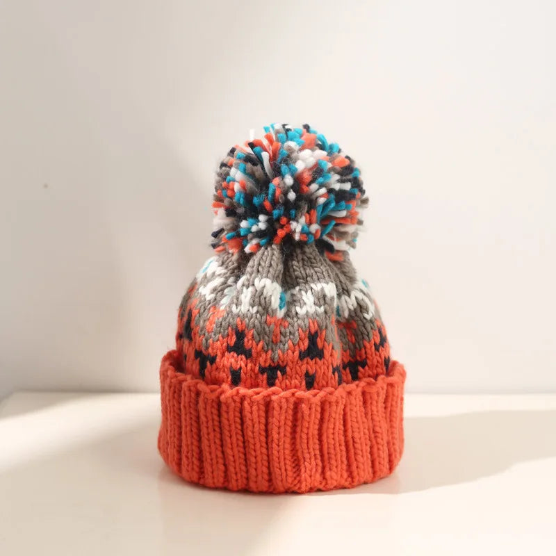 Fashionable women's snowflake pom beanie, a cozy and warm accessory for cold weather and casual style.