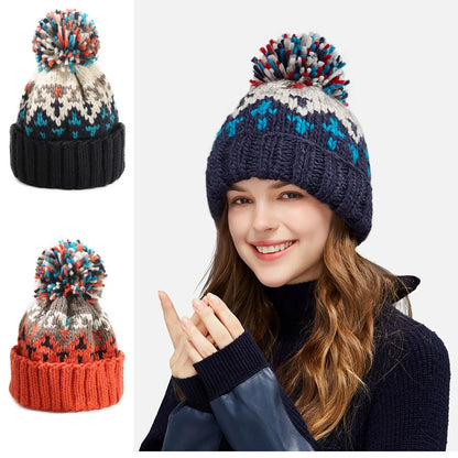 Warm women's knit beanie with a festive snowflake design and a fluffy pompom, ideal for cozy winter fashion.