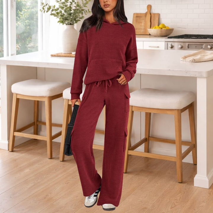 Women's modern knit two-piece lounge outfit: a cozy hoodie and elegant wide-leg trousers.