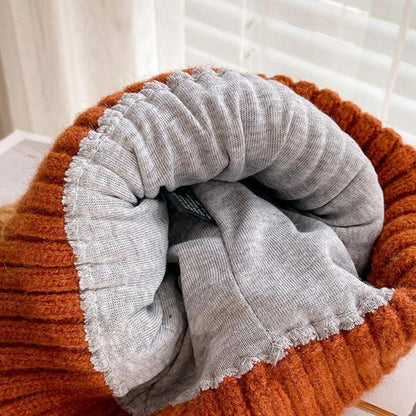 Fashionable women's knit winter hat with cute cat ears, offering cozy warmth and playful style.