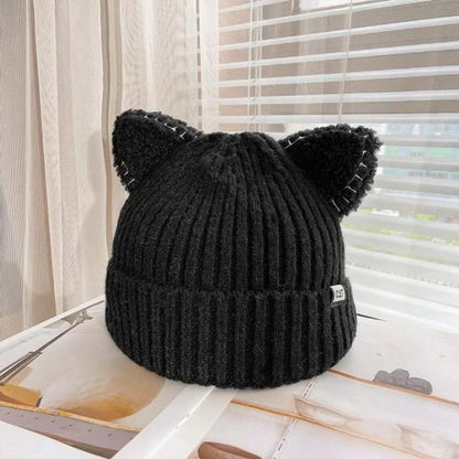 Warm women's knit winter hat with cute cat ears, ideal for staying cozy and stylish in the cold.