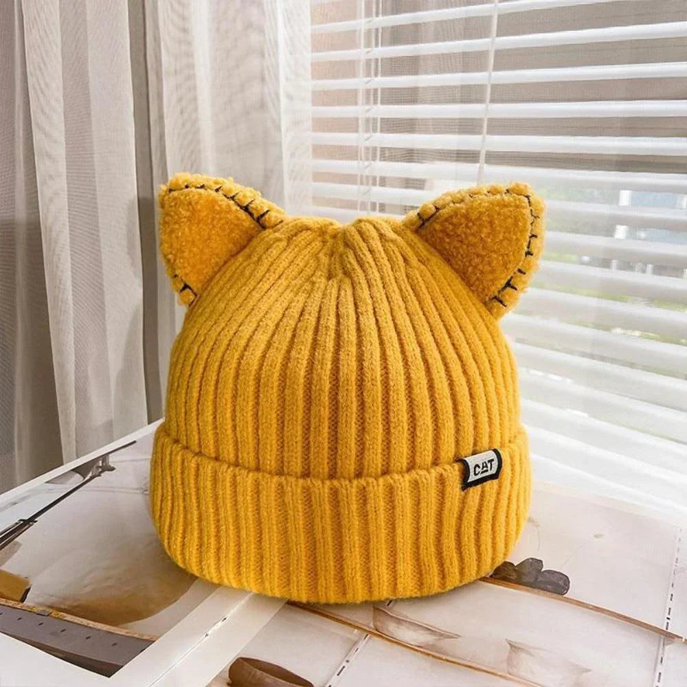 Stay warm with this women's cozy knit winter hat, adorned with adorable cat ears for a playful look.
