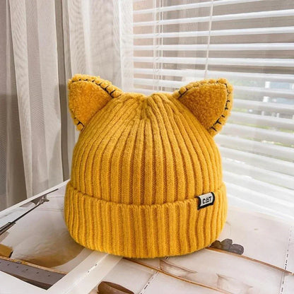 Stay warm with this women's cozy knit winter hat, adorned with adorable cat ears for a playful look.