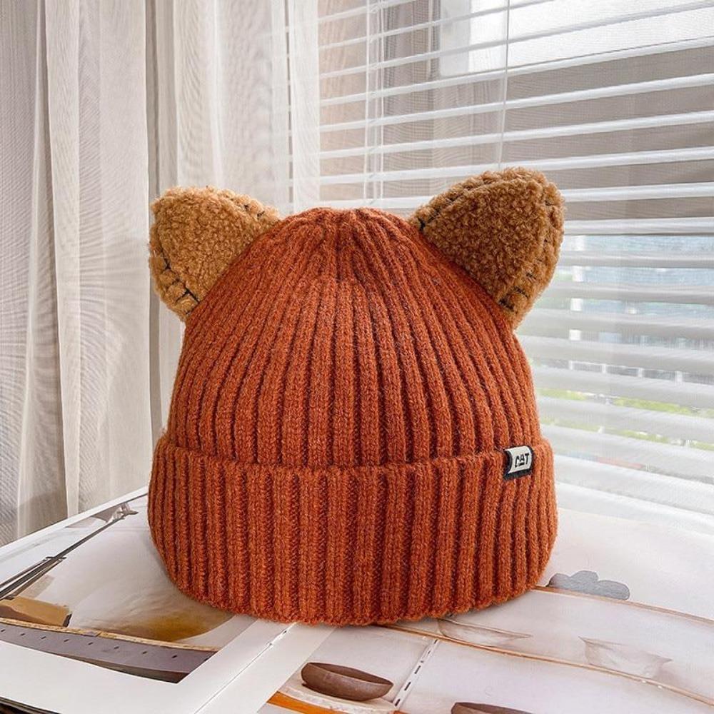 Playful women's winter knit hat with cozy fabric and charming cat ears, a warm cold-weather essential.