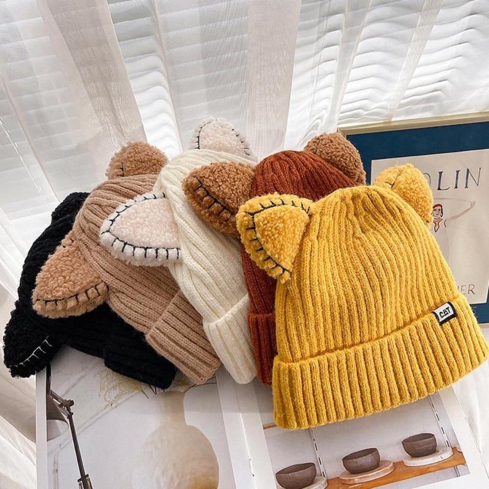 Trendy women's knit winter hat featuring playful cat ears; a warm and cozy headwear accessory.