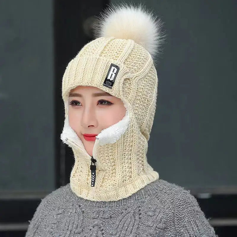 Women's cozy knitted balaclava with pompom, offering ultimate winter warmth for cold weather protection.