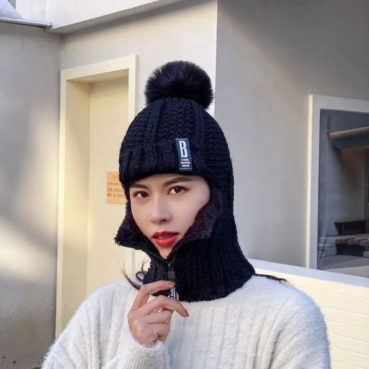 Soft wool blend women's knitted balaclava with a cute pompom, providing cozy headwear for extreme cold.
