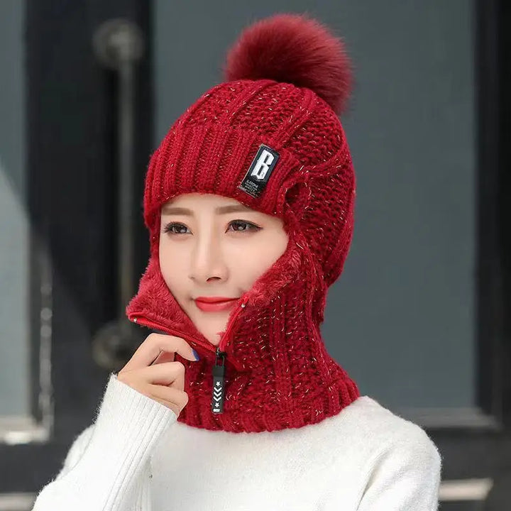 Comfortable women's knitted balaclava with pompom, a warm hat perfect for chilly days and winter activities.
