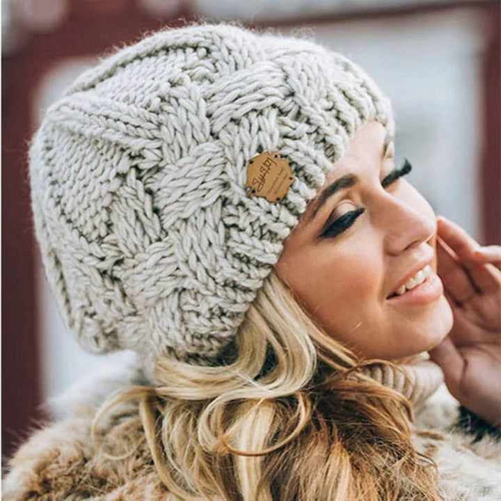 Women's cozy knitted winter beanie hat in a stylish design, perfect for warmth and fashion.